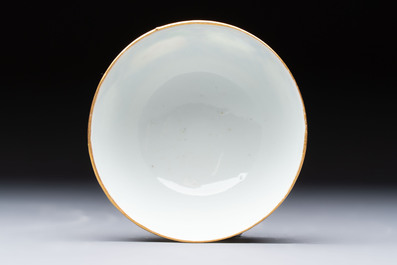 A Chinese famille rose gilt-decorated cup and saucer with figural design, Jiaqing