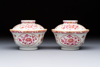 A pair of Chinese famille rose gilt-decorated covered cups and saucers and an openworked cup, Qianlong