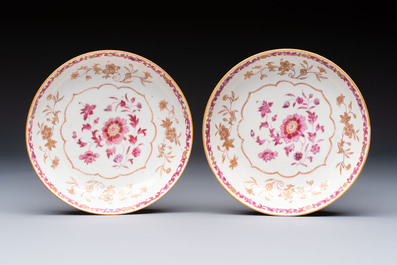 A pair of Chinese famille rose gilt-decorated covered cups and saucers and an openworked cup, Qianlong