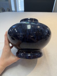 A Chinese flamb&eacute;-glazed vase on a wooden stand, 19th C.
