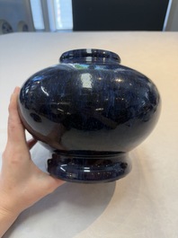 A Chinese flamb&eacute;-glazed vase on a wooden stand, 19th C.