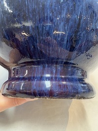 A Chinese flamb&eacute;-glazed vase on a wooden stand, 19th C.
