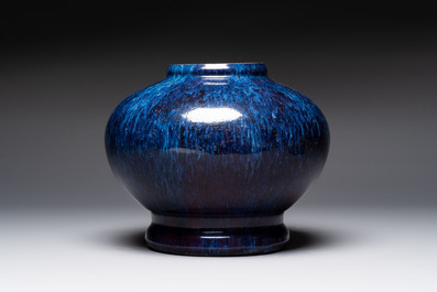 A Chinese flamb&eacute;-glazed vase on a wooden stand, 19th C.