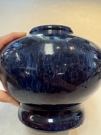 A Chinese flamb&eacute;-glazed vase on a wooden stand, 19th C.