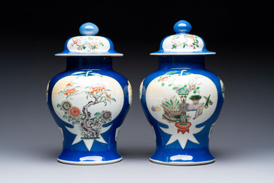 Two Chinese famille verte blue-ground vases and covers, 19th C.