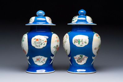 Two Chinese famille verte blue-ground vases and covers, 19th C.