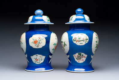 Two Chinese famille verte blue-ground vases and covers, 19th C.