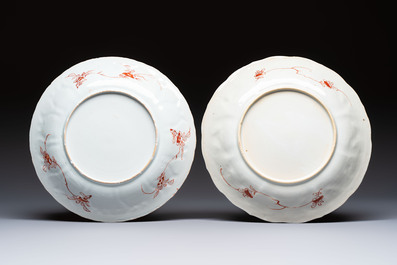 A pair of Chinese iron-red and gilt-decorated 'Elegant Beauties in a Garden' dishes, Kangxi