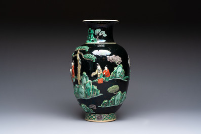 An unusual Chinese famille noire vase with relief design, Kangxi mark, 19th C.