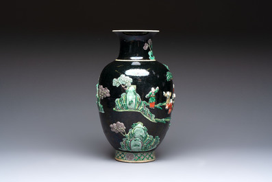 An unusual Chinese famille noire vase with relief design, Kangxi mark, 19th C.