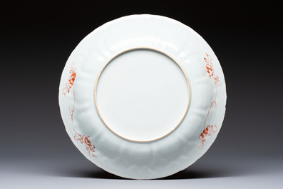 A Chinese iron-red and gilt-decorated dish with a garden scene, Kangxi