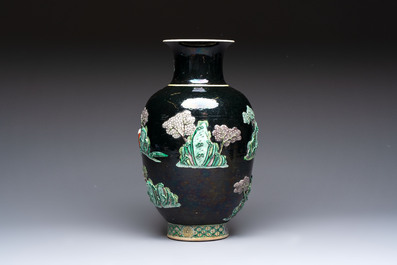 An unusual Chinese famille noire vase with relief design, Kangxi mark, 19th C.