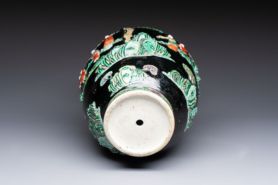 An unusual Chinese famille noire vase with relief design, Kangxi mark, 19th C.