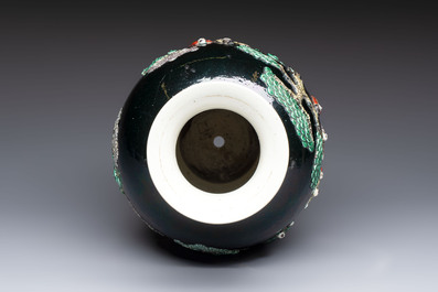 An unusual Chinese famille noire vase with relief design, Kangxi mark, 19th C.