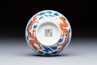 A Chinese iron-red decorated blue and white 'Dragon' saucer and a cup, Yongzheng and Tongzhi mark, 19/20th C.