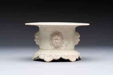 A Chinese qingbai censer with masks in relief, 20th C