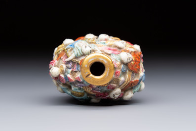 A Chinese famille rose moulded '18 Luohan' snuff bottle, Qianlong mark, 19th C.