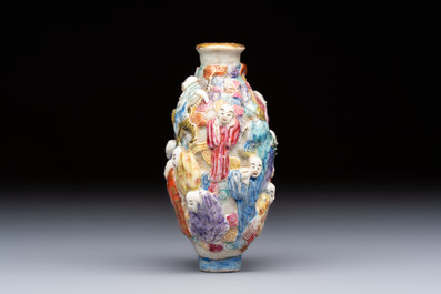 A Chinese famille rose moulded '18 Luohan' snuff bottle, Qianlong mark, 19th C.