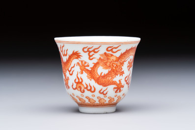 A Chinese iron-red decorated blue and white 'Dragon' saucer and a cup, Yongzheng and Tongzhi mark, 19/20th C.