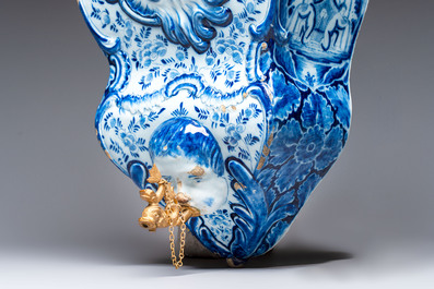 A large blue and white Dutch Delft 'Fountain of Youth' wall cistern with impressive reticulated gilt bronze cover, 18th C.