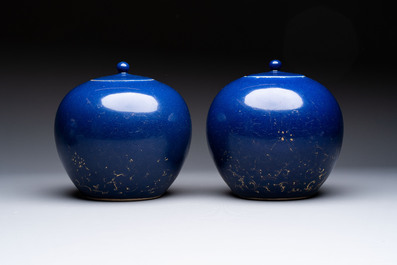 A pair of Chinese gilt-decorated powder-blue-ground covered jars and a famille rose powder-blue-ground jar, 18/19th C.