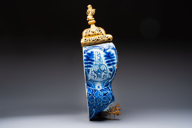 A large blue and white Dutch Delft 'Fountain of Youth' wall cistern with impressive reticulated gilt bronze cover, 18th C.