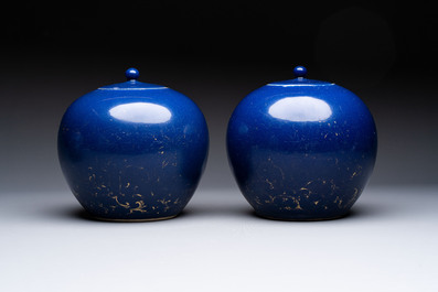 A pair of Chinese gilt-decorated powder-blue-ground covered jars and a famille rose powder-blue-ground jar, 18/19th C.