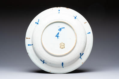 A large manganese, blue and white Dutch Delft chinoiserie dish, 17th C.