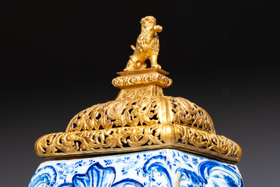 A large blue and white Dutch Delft 'Fountain of Youth' wall cistern with impressive reticulated gilt bronze cover, 18th C.