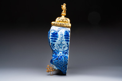 A large blue and white Dutch Delft 'Fountain of Youth' wall cistern with impressive reticulated gilt bronze cover, 18th C.