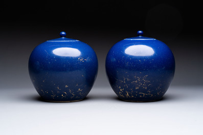A pair of Chinese gilt-decorated powder-blue-ground covered jars and a famille rose powder-blue-ground jar, 18/19th C.