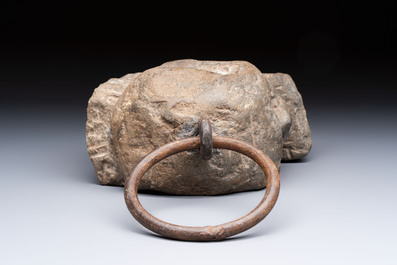An Italian carved Serena stone 'Memento Mori' in the form of a skull with a wrought-iron suspension ring, probably Tuscany, 17th C.