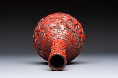 Two Chinese cinnabar lacquer covered boxes and a bottle vase, 19th C.