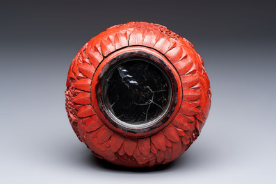 Two Chinese cinnabar lacquer covered boxes and a bottle vase, 19th C.