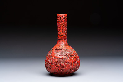Two Chinese cinnabar lacquer covered boxes and a bottle vase, 19th C.