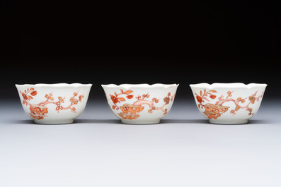 Three fine Chinese eggshell iron-red and gilt-decorated 'Boy and Goats' cups and saucers, Yongzheng