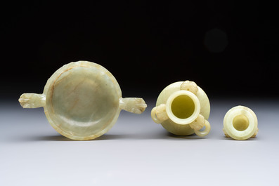 A Chinese celadon jade covered vase, with wooden stand, and a bowl with wooden cover and stand, 19/20th C.