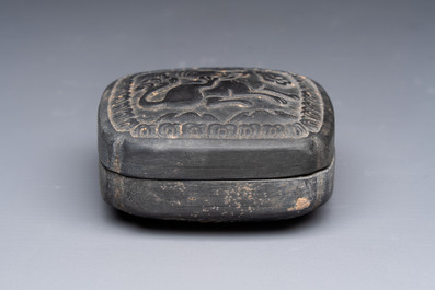 A Chinese carved black pottery 'Mythical Animal' box and cover, Yuan/Ming