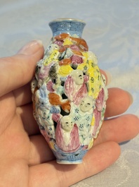 A Chinese famille rose moulded, reticulated and double-walled '18 Luohan' snuff bottle, Qianlong mark, 19th C.