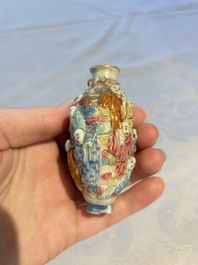 A Chinese famille rose moulded '18 Luohan' snuff bottle, Qianlong mark, 19th C.