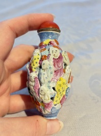 A Chinese famille rose moulded, reticulated and double-walled '18 Luohan' snuff bottle, Qianlong mark, 19th C.
