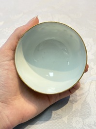 A Chinese famille rose gilt-decorated cup and saucer with figural design, Jiaqing