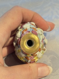 A Chinese famille rose moulded, reticulated and double-walled '18 Luohan' snuff bottle, Qianlong mark, 19th C.