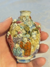 A Chinese famille rose moulded '18 Luohan' snuff bottle, Qianlong mark, 19th C.