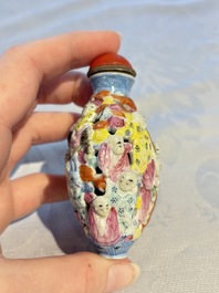 A Chinese famille rose moulded, reticulated and double-walled '18 Luohan' snuff bottle, Qianlong mark, 19th C.