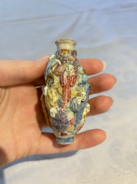 A Chinese famille rose moulded '18 Luohan' snuff bottle, Qianlong mark, 19th C.