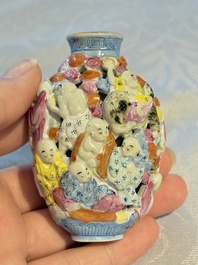A Chinese famille rose moulded, reticulated and double-walled '18 Luohan' snuff bottle, Qianlong mark, 19th C.