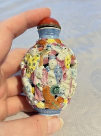 A Chinese famille rose moulded, reticulated and double-walled '18 Luohan' snuff bottle, Qianlong mark, 19th C.