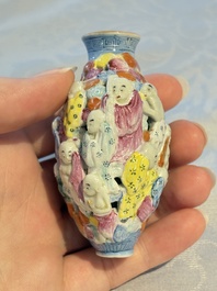 A Chinese famille rose moulded, reticulated and double-walled '18 Luohan' snuff bottle, Qianlong mark, 19th C.