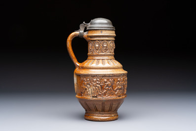 A Raeren stoneware 'Peasants Dance' jug with a mounted pewter lid, dated 1587